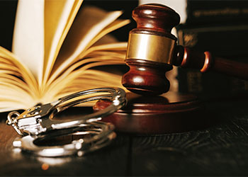 Handcuff, Law Book and Gavel