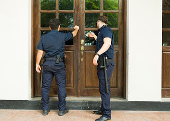 Police officers doing a home investigation searching for evidence