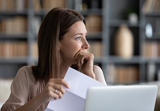 Stressed Young Woman Holding Bankruptcy Paper Document