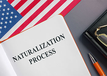 Naturalization process law book and USA flag with pen