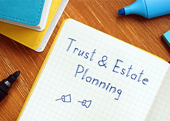 Trust & Estate Planning written on a notebook