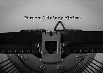 Text Personal injury claims typed on retro typewriter