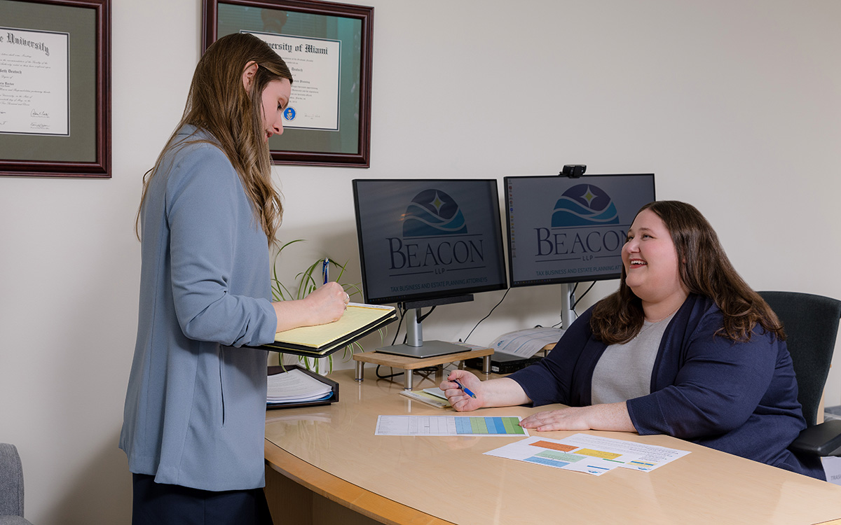 Erica B. Deutsch talking with Brittany Hansen at the office.