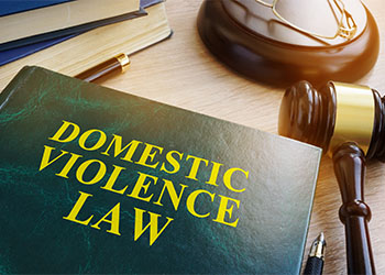 Domestic violence law book and gavel on a wooden table