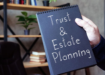 Trust and Estate Planning written in a notebook