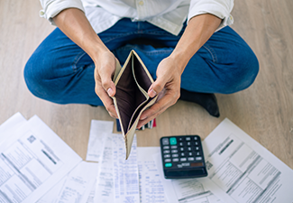 A Businessman Sitting on The Floor of The House Opening Empty Wallet