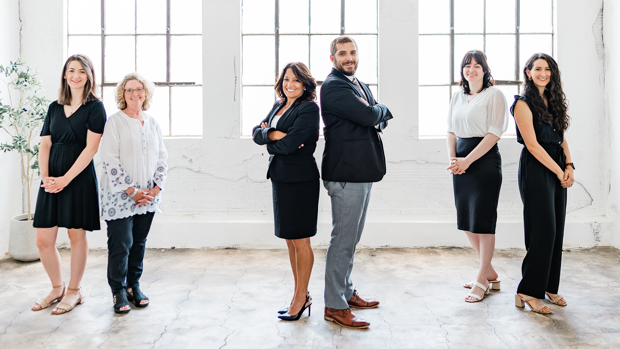 McKelvey Law Offices, members posing with their backs to each other