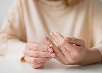 Woman divorcing and taking off wedding ring