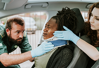 Paramedic Placing a Cervical Collar to An Injured Woman