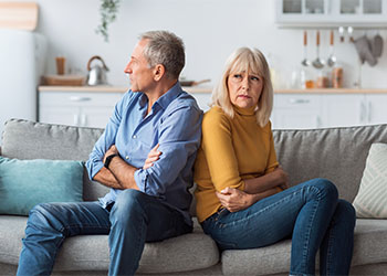 Offended Senior Couple Sitting Back-To-Back Having Marital Crisis