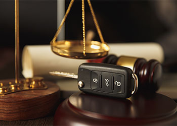 Close up of judge gavel and car keys over soundboard