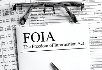 Paper with text FOIA The Freedom of Information Act on a table