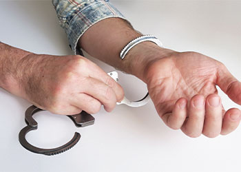 Man opens handcuffs, concept of bail