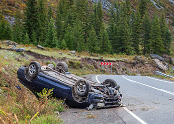 Overturned car lies on the roof