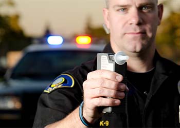 Police officer with breath analyzer