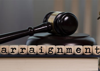 Word ARRAIGNMENT composed of wooden dices and gavel