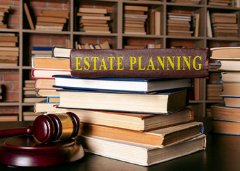 Estate Planning Law Book on top of other books and gavel 