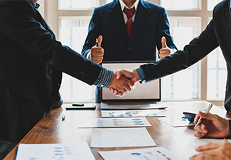 Business people shake hands while negotiating a business deal