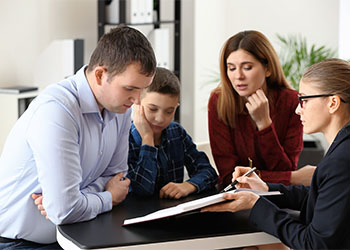 Divorced parents with their son visiting lawyer