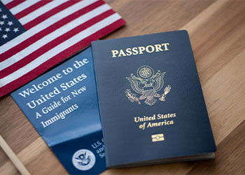 Passport of USA next to a Guide for new Immigrants