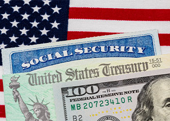 Social security card, 100 dollar bill and American flag