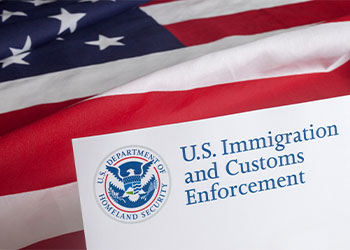 US Immigration and Customs Enforcement letter pad and flag of USA