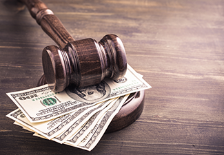 Gavel and dollars banknotes on table