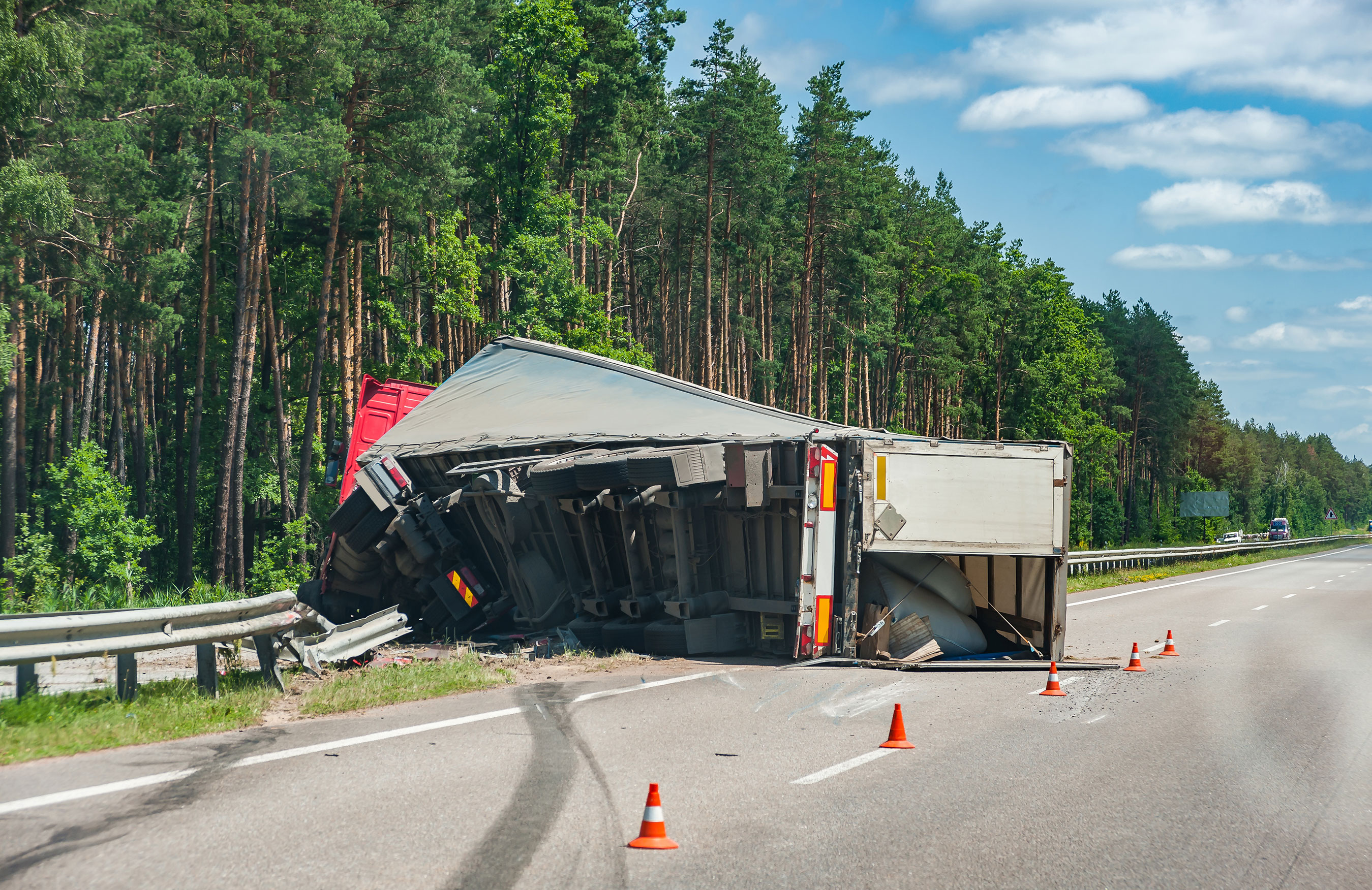 18-wheeler truck tipped over on the side of the road