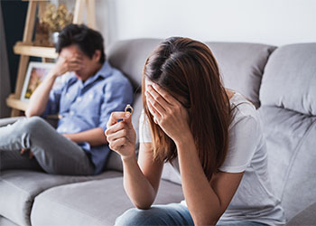 Wife taking off the wedding ring after argument with husband