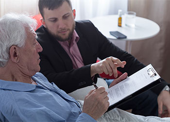 Old man signing his will