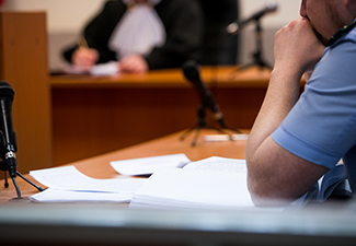 A person listening to the judge in the court room