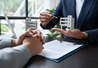 A young agent explains the details of the condo purchase