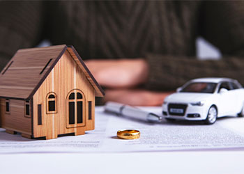 Wedding ring with divorce paper, house and car model 