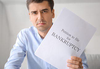 Stressed man with petition to file for bankruptcy at home