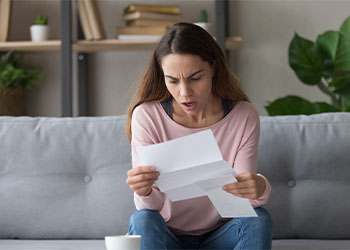 Woman stunned by bad news in letter