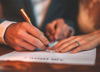 Couple signing Prenuptial Agreement