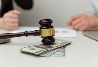 Closeup view of wooden gavel and money