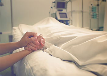 Women holding hand of a dead person