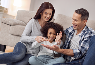 Pretty inspired curly-haired smiling and having fun with her parents