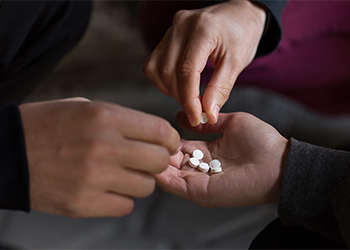 Teenagers distributing drug pills