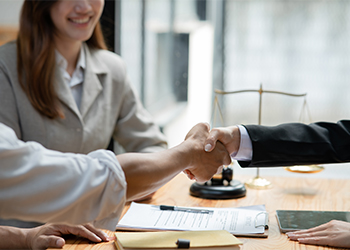 Shaking hands in attorney office after successful mediation