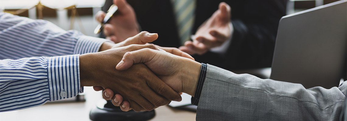 Shaking hands after successful mediation in attorney office