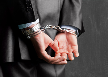 Handcuffed man in suit