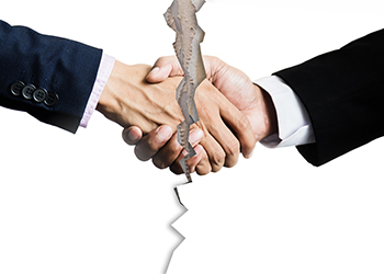 Breakage in handshake symbolizing partnership dissolution