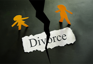 Torn piece of paper with divorce text and paper couple figures