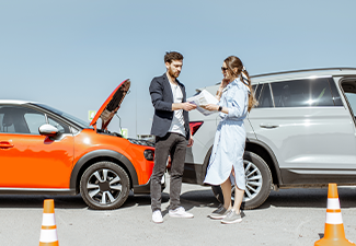 Man and woman arguing, standing together on the road after accident