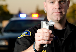 Policeman Holding Breath Tester for DWI Check
