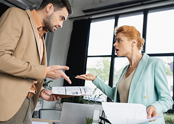 Business Partners holding documents and arguing in office