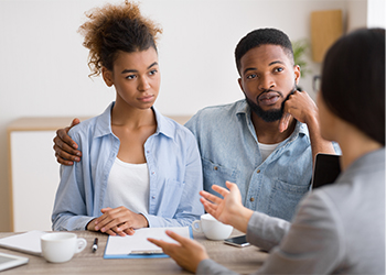 Young couple discussing estate plan with attorney