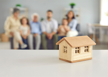 House model and family in the background